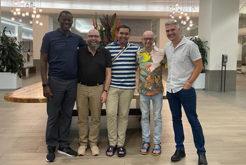 Five men standing together for a group photo