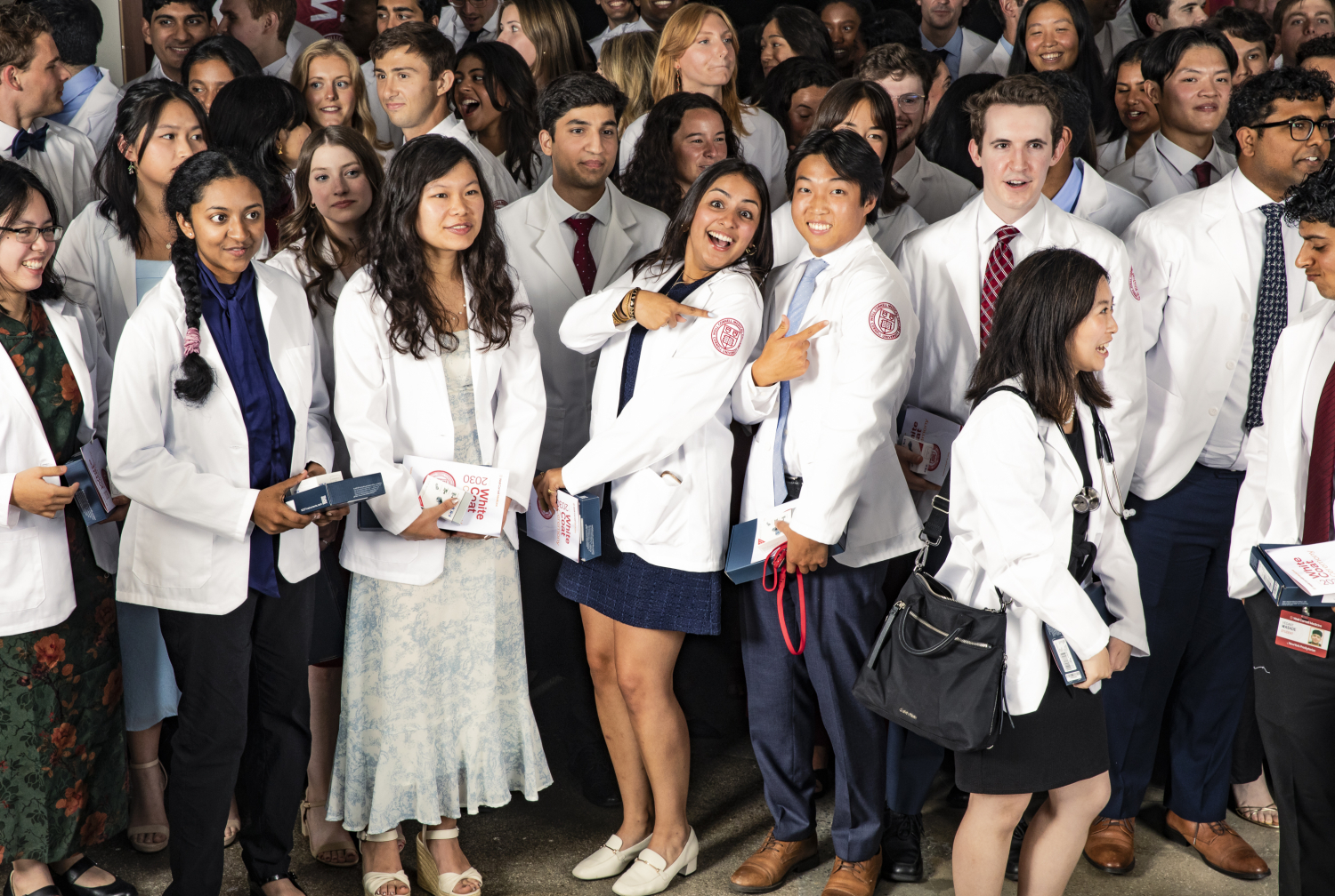 A group of students wearing white coats