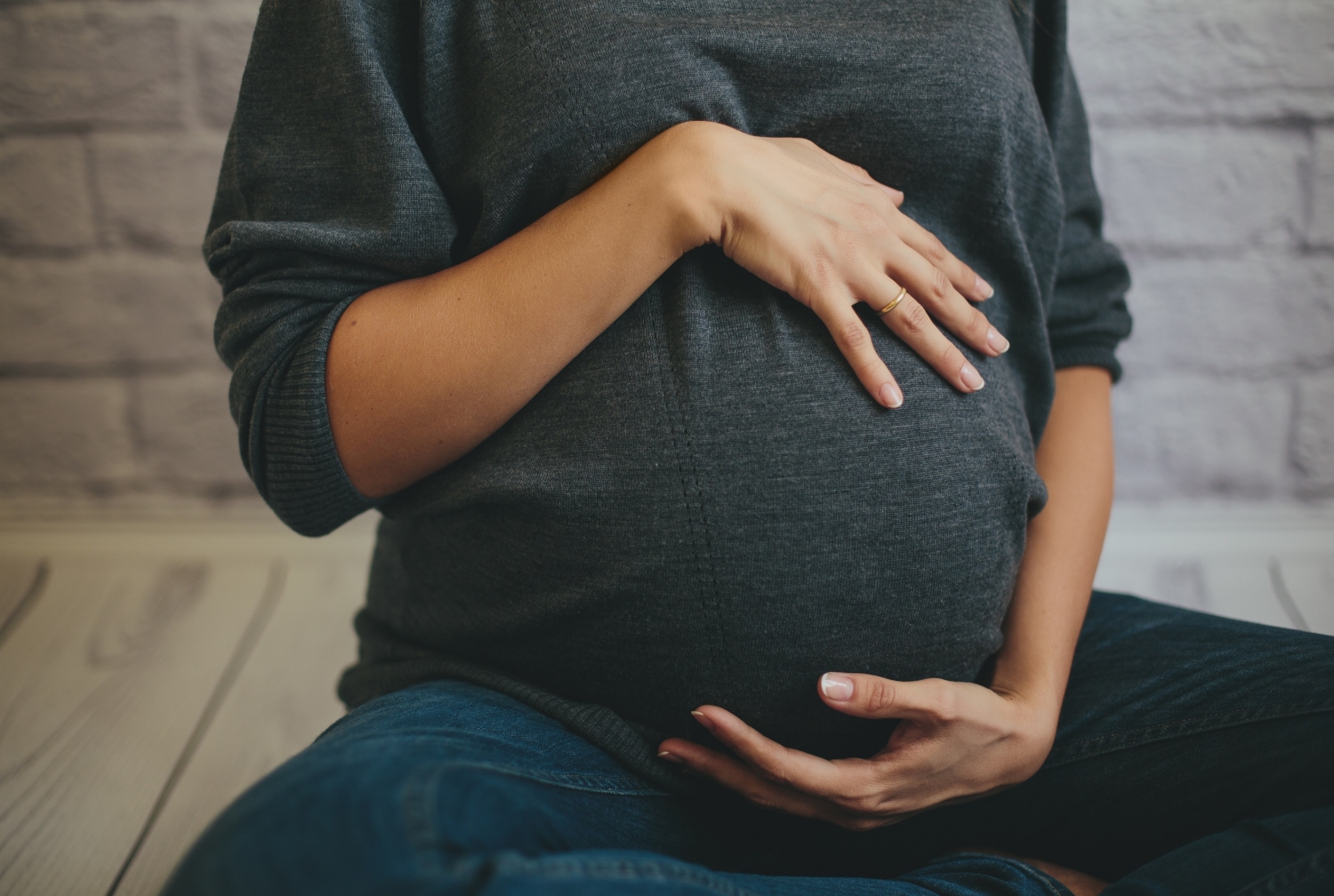a pregnant woman holding her stomach