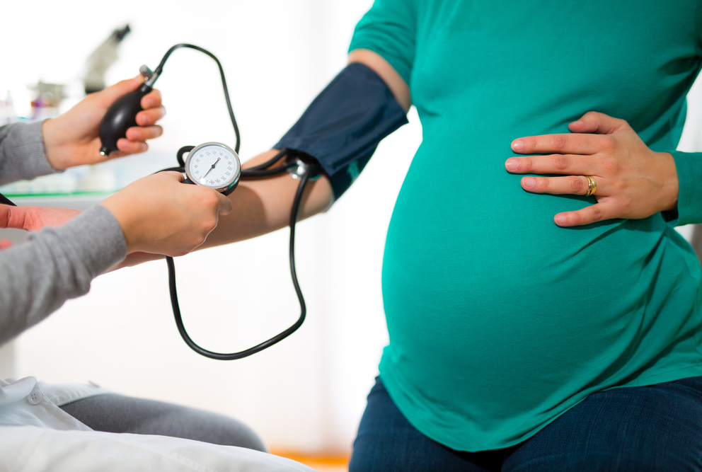 pregnant woman having blood pressure taken