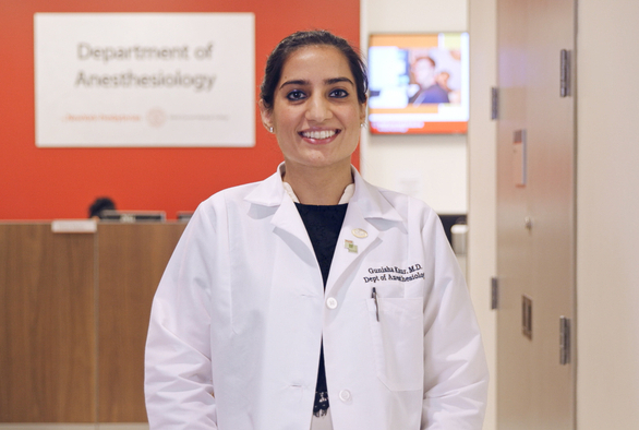 A woman wearing a white coat