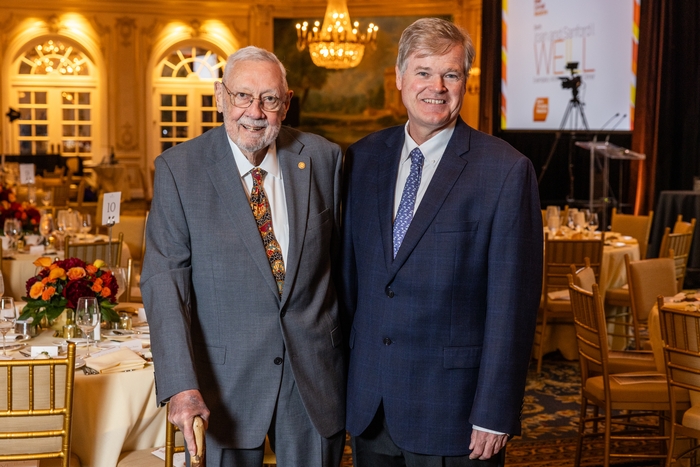 Two men posing for a photo at a gala.