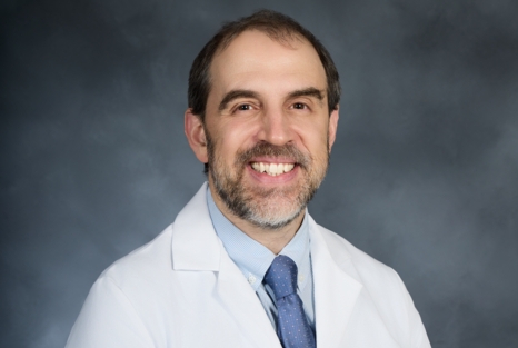 Headshot of a physician wearing a white coat.