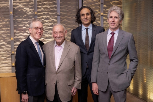 Four men taking a group photo