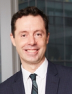 Dr. Olivier Elemento a man in a suit posing for a picture