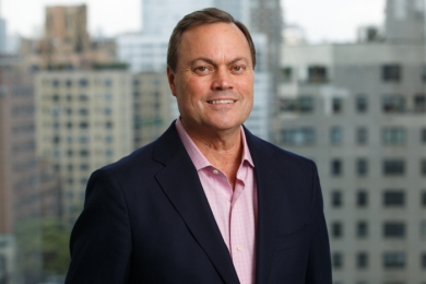 a man wearing a salmon button down shirt and a sports jacket