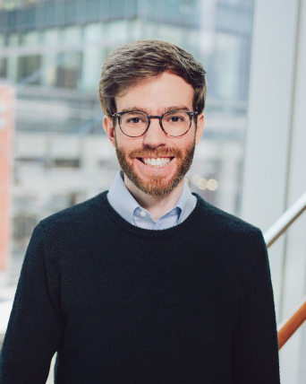 Headshot of a man in front of a window