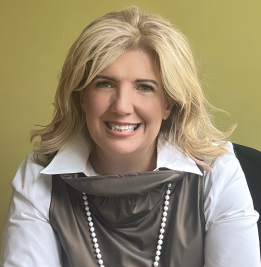 A woman sitting down for a photo