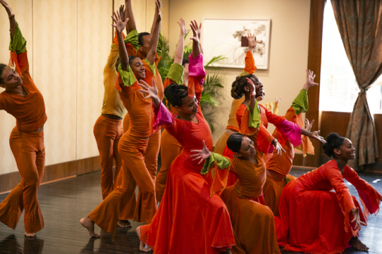 dancers in orange costumes
