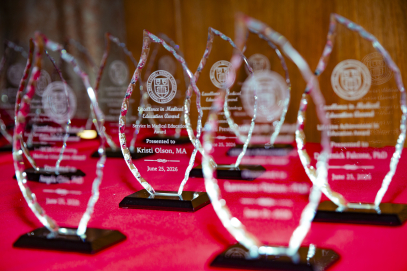 Trophies on a table with a red tablecloth