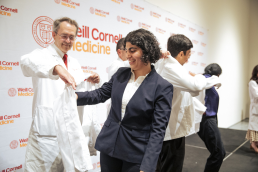 A student getting coated by a faculty member