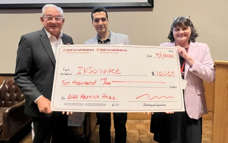 an older man, a young man and a middle-aged woman) holding a big check of $10,000.