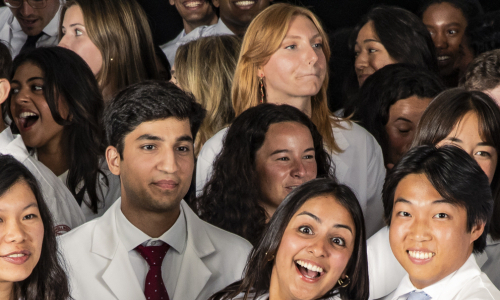 A group of students wearing white coats