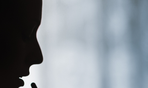 silhouette of a woman taking a pill