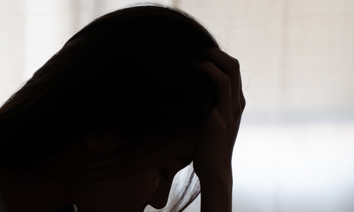 silhouette of a woman with her head in her hand