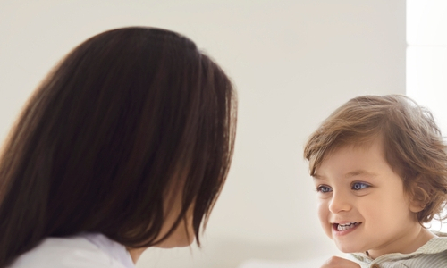 A pediatrician examining a child with a stethoscope.
