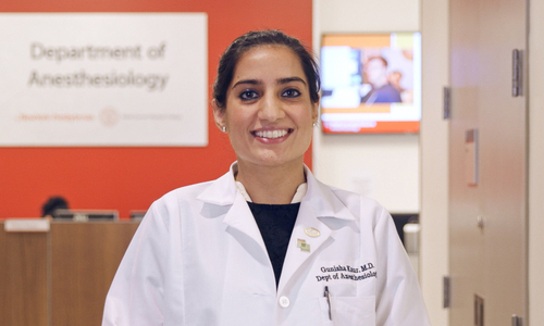 A woman wearing a white coat