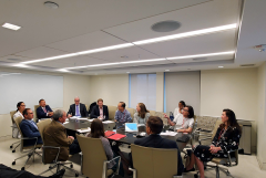 a group of medical professionals in a room having a meeting