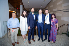 Six people (four men and two women) wearing business attire in a group photo