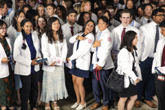 A group of students wearing white coats