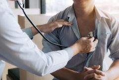 doctor checking heartbeat