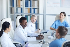 group of doctors sitting around a table