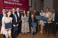 A group of students and education administration pose for a photo